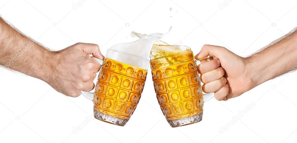 hands holding beer mugs making toast