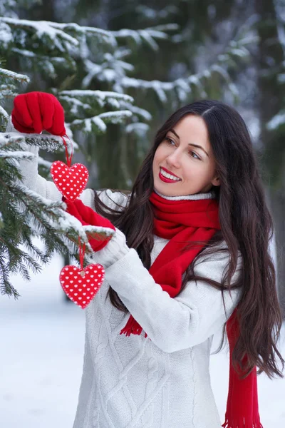 girl with red heart in winter outdoor