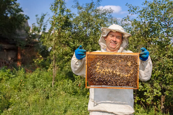 beekeeper with honeycomb