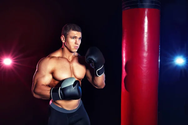 man boxing punching bag