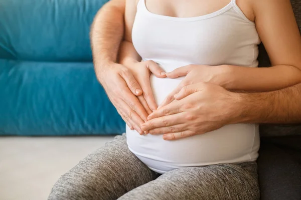Donna incinta con le mani a forma di cuore sulla pancia — Foto Stock
