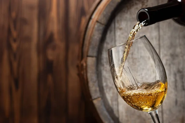 Pouring white wine in glass — Stock Photo, Image