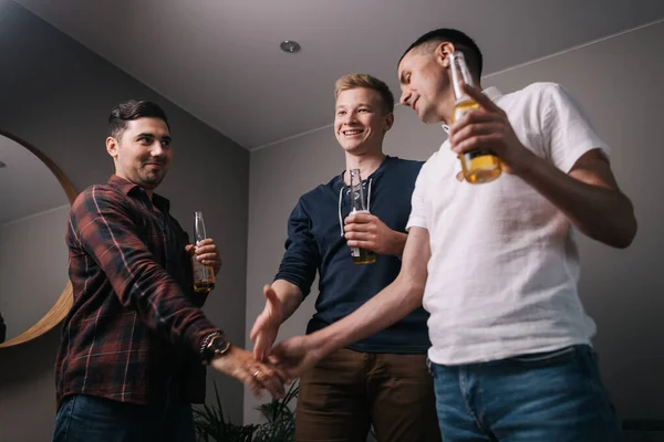 Friends make bets. Guy breaks his friends handshake with his hand