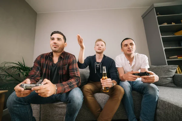 Cheerful company of friends emotional playing video games have fun
