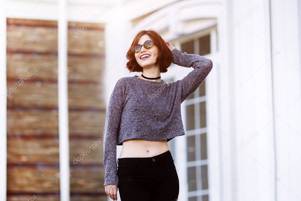 Outdoor fashion portrait of stylish hipster cool girl wearing sunglasses