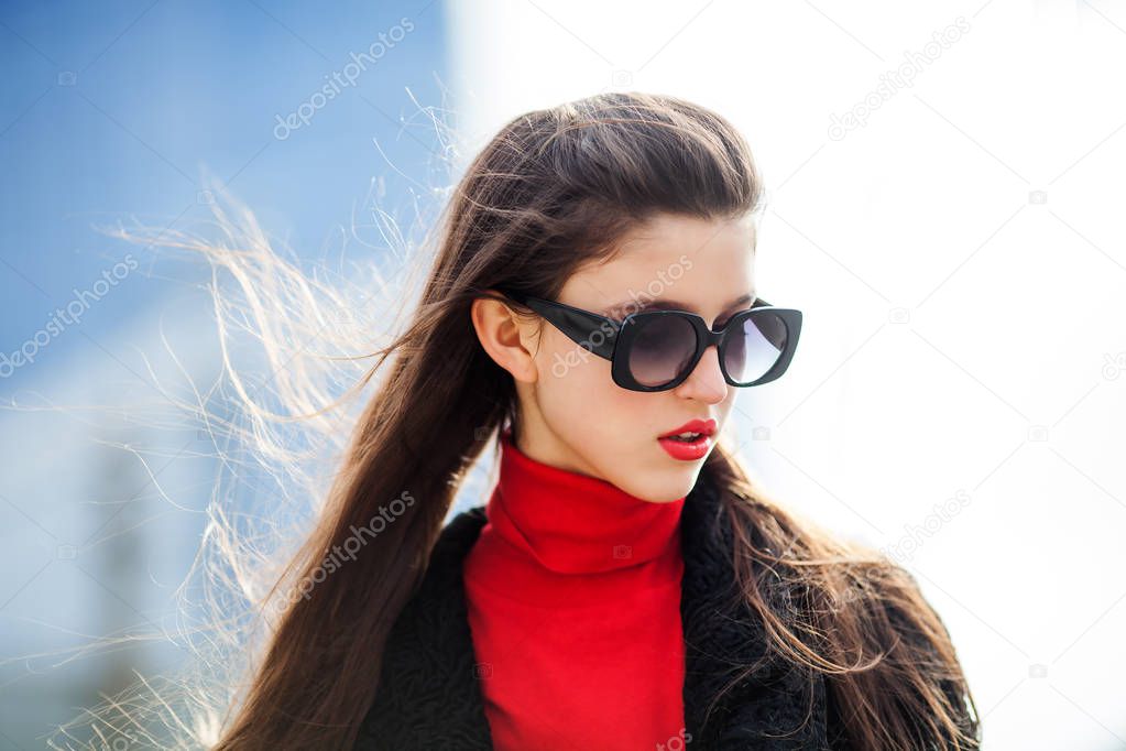 Close up fashion street stile portrait of pretty girl in fall casual outfit. Cool girl with long hairstyle and red lips