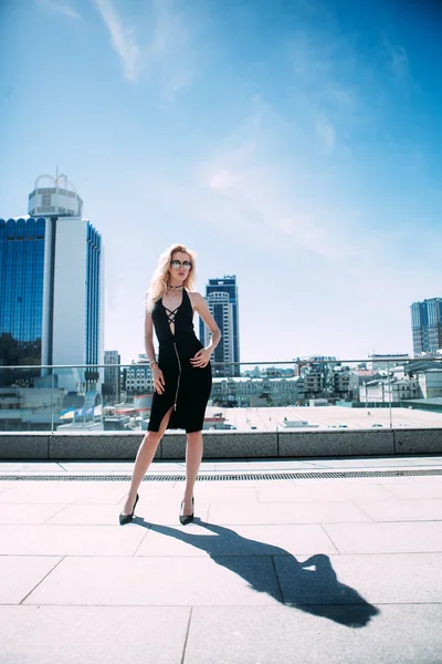 Açık tüm vücut sokakta poz genç güzel bir moda kadın portresi. Kameraya bakarak modeli. Bayan şık kıyafetler giyiyor. Kadın moda kavramı. Şehir yaşam tarzı