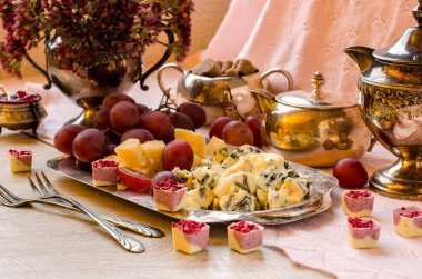 Peynir ve gümüş bir tepside üzüm.