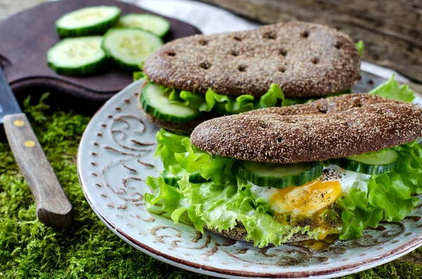 Healthy food - sandwiches of dark bread and poached eggs.