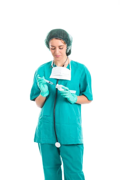 Young nurse with stethoscope standing and looking syringe in hand isolated . — Stock Photo, Image