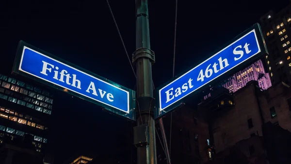 Street sign of Fifth Ave and East 41St with skylines in background.- New York, USA