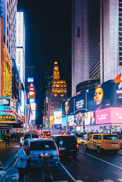 Times Square, featured with Broadway Theaters and animated colorful LED signs, stores, and lots of tourists and locals, is a symbol of NYC and the USA in Manhattan.