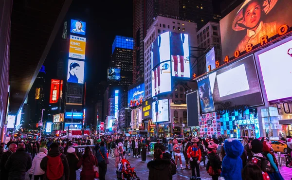 New York City, USA- March 18, 2017: Times Square, featured with Broadway Theaters and animated colorful LED signs, stores, and lots of tourists and locals, is a symbol of NYC and the USA in Manhattan. — Stock Photo, Image