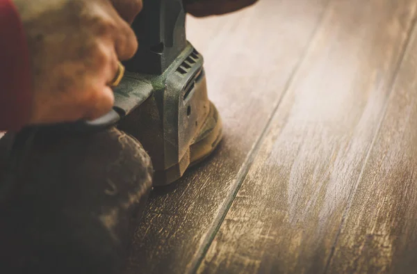 Craftsman hands polishing old color from wooden table with machine. Toned Image. — Stock Image Craftsman hands polishing old color from wooden table with machine. Toned Image. Stock Photo