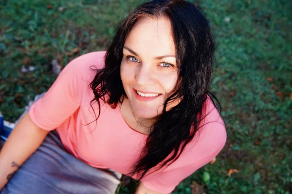 Dışarıda gülümseyen genç bir kadının portresi.