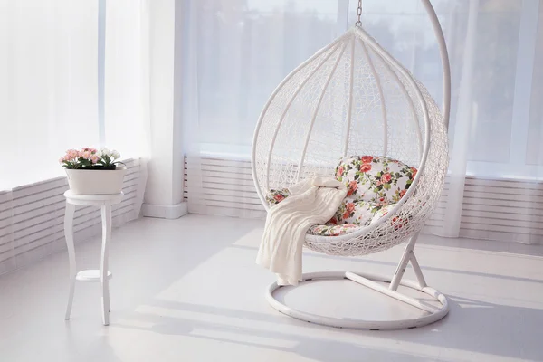 big oval white artistic chair in a white room