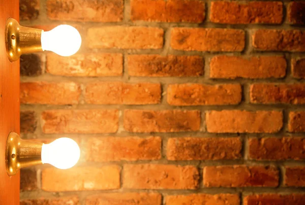 Light bulbs over brick wall texture