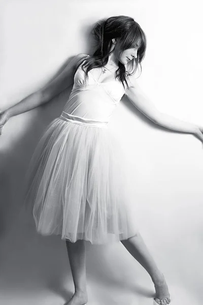 tender sensual girl in a white T-shirt and a tulle skirt. Black