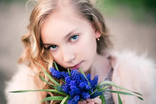 Álmodozó lány és egy csokor kék virágok — Stock Fotó