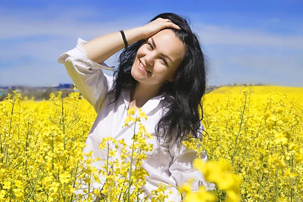 Girl in white shirt at the yellow flower field — Stock Photo, Image