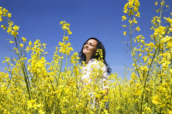 Girl in white shirt at the yellow flower field — Stock Photo, Image