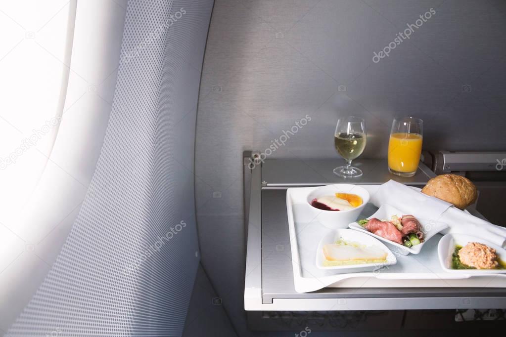 Food served on board of business class airplane on the table