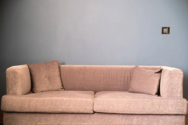 Brun soffa framför blå vägg — Stockfoto