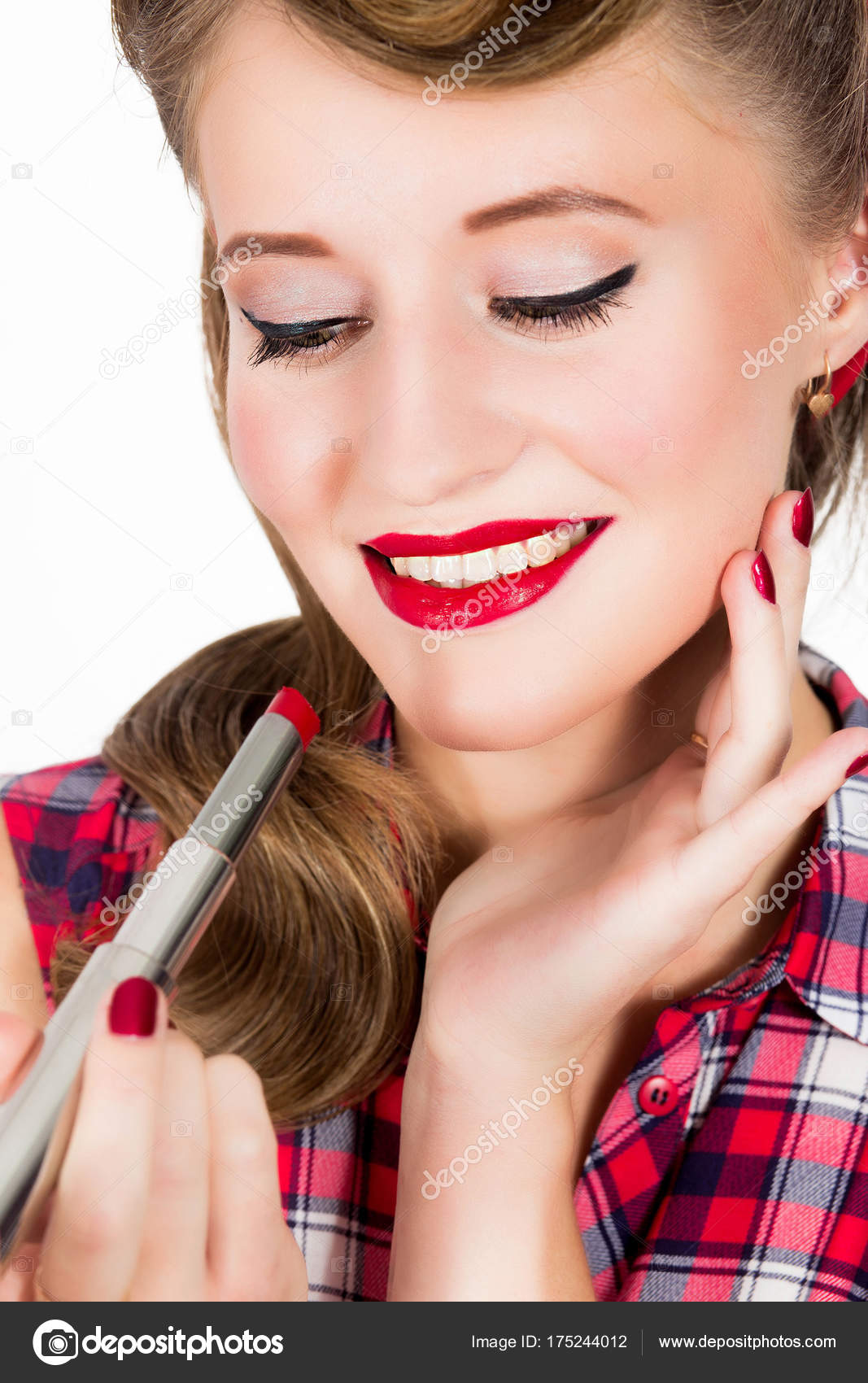 Woman With Pin Up Hairstyle Applying Red Lipstic Stock Photo