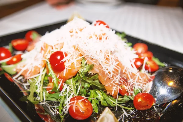 Salmon carpaccio with arugula and cheese — Stock Photo, Image