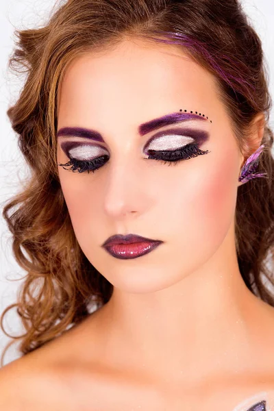 Beautiful model with fashion makeup looks down. Eyes lowered and looking down — Stock Photo, Image