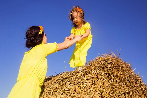 mom hands out her hand to her daughter