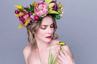 başında parlak çiçekler ile güzel genç kadın model