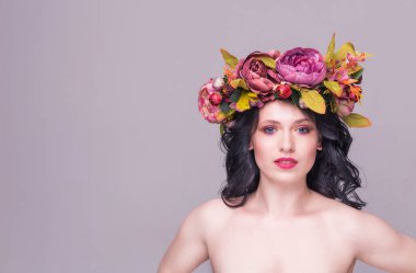 Mor arka planda parlak çiçekli güzel esmer kadın manken.