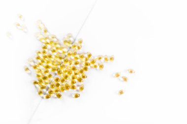  CBC yağ kapsülleri beyaz ayna arka planında izole edilmiş. Üst görünüm