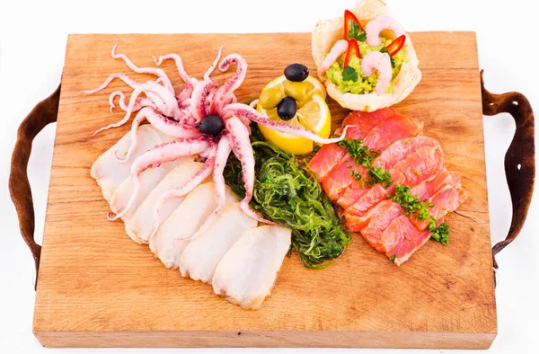 Fish platter on a wooden board on a white background. Horizontal photo