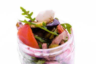 Sığır etli salata, patlıcan ve ızgara domates, roka ve cam kavanozda yumurta. Nesne beyaz bir arkaplanda izole edilmiştir. Yatay fotoğraf