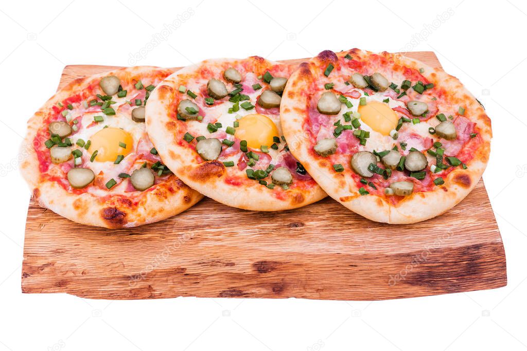 Three pizzas with ham, egg, pickled cucumber on a wooden tray. The object is isolated on a white background. Horizontal photo