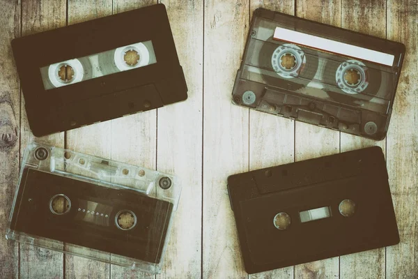 Old cassette tapes with a wooden — Stock Photo, Image
