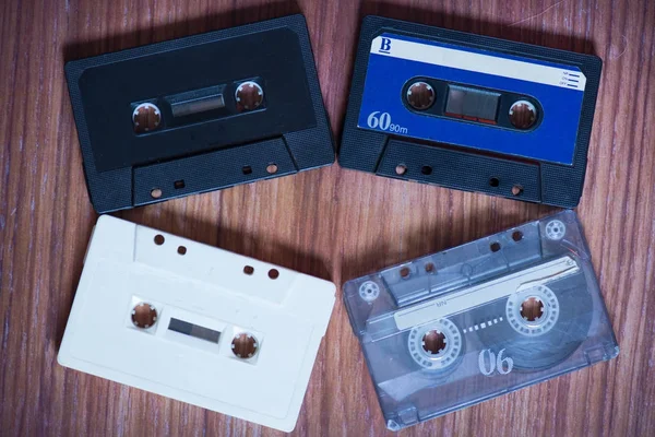 Old cassette tapes with a wooden background — Stock Photo, Image