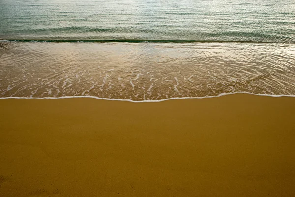 Golven op de kust op het gouden zand — Stockfoto