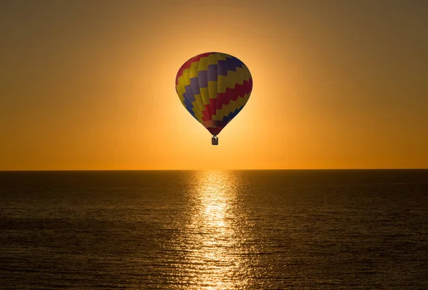 Aerostatic ballon in de zee op een zonsopgang — Stockfoto