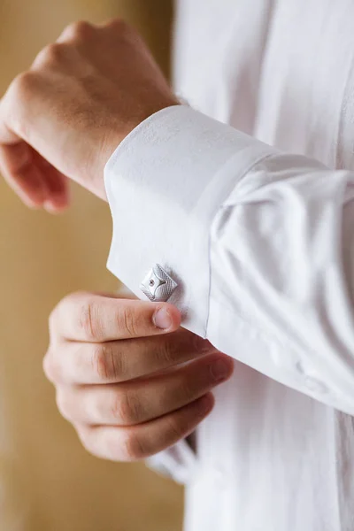 Ο άνθρωπος διορθώνει τα μανικετόκουμπα σε ένα πουκάμισο. ο γαμπρός βάζει γάμου. — Φωτογραφία Αρχείου