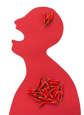 the contour of the person cut from red paper on a white background with an open mouth and hot red peppers lying inside him. concept of heartburn, gastritis, spicy food, strong ilness. flat lay. clipart