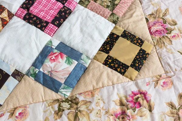 Part of color patchwork quilt with vintage flowers pattern as background. Colorful Scrappy blanket. Hobby Concept. — Stock Photo, Image