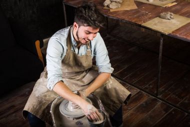 Clay bir bükülmüş potters tekerlek üzerinde kupa oluşturma. Bir sürahi toprak dışında heykeltraş atölye yapar.