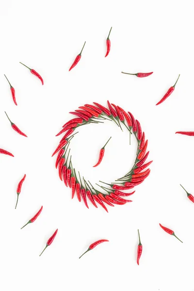 Червоний гарячий перець чилі, популярна концепція спецій - декоративна кругла фігура, що складається з декількох стручків червоного гарячого перцю, посередині один стручок, красивий колаж лежачого перцю, вид зверху, плоский — стокове фото