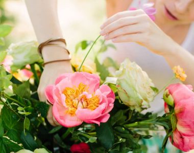 buket, bayram, insanlar ve çiçek düzenleme kavramı - yakın çekim güzel buket pembe hawaiian mercan Şakayık ve beyaz gül, genç kız çiçekçi beyaz bir çalışma yapma kadın Tasarımcısı'nın ellerinde