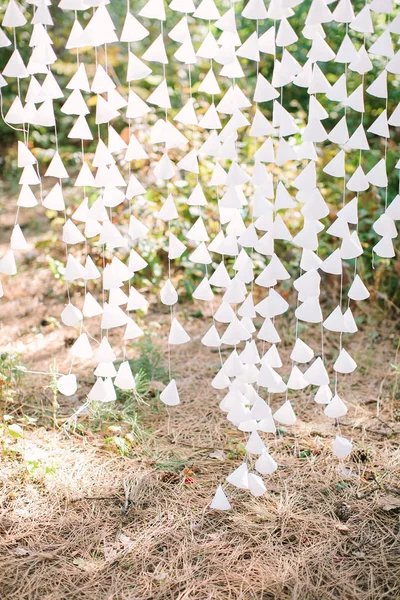 Elementos de cone de papel branco amarrados no fio como parte de uma decoração de casamento, ao ar livre . — Fotografia de Stock