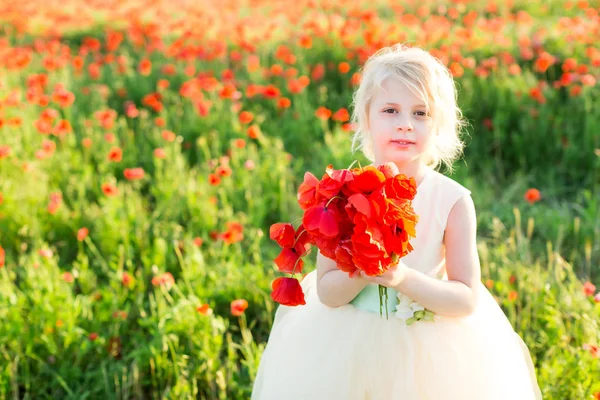 nature, flora, ecology, future generation, childcare, celebration concept - little cute fair-haired girl with bunny teeth in white party dress holding bouquet of bright red poppies