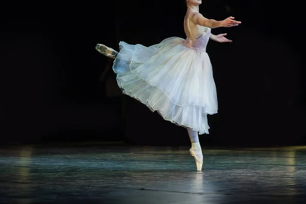 entertainment, art, choreography concept. gorgeous graceful ballerina dressed in blinding white ball gown dancing solo part all alone on the stage of the theater